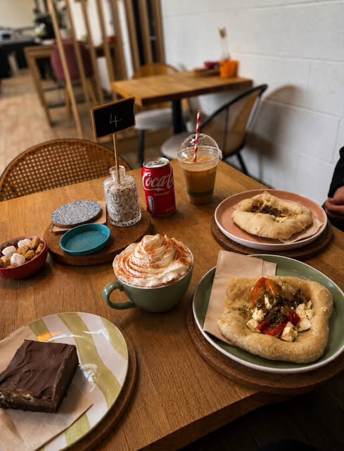 Coffee, drinks and plates of food on a café table