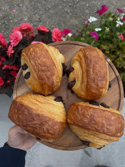 A tray of pastries outside among the garden-centre flowers